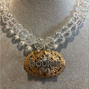 Elegant faceted glass crystal necklace with gold tone and silver pendant!